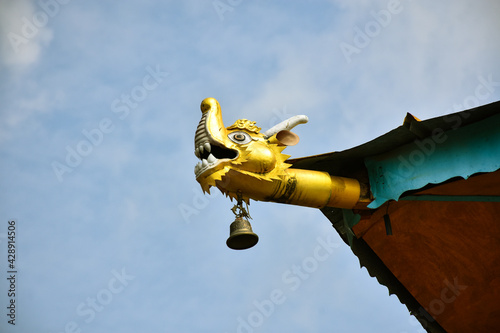 Tablou pe pânză Budhist art of Dragon face with chiming bell