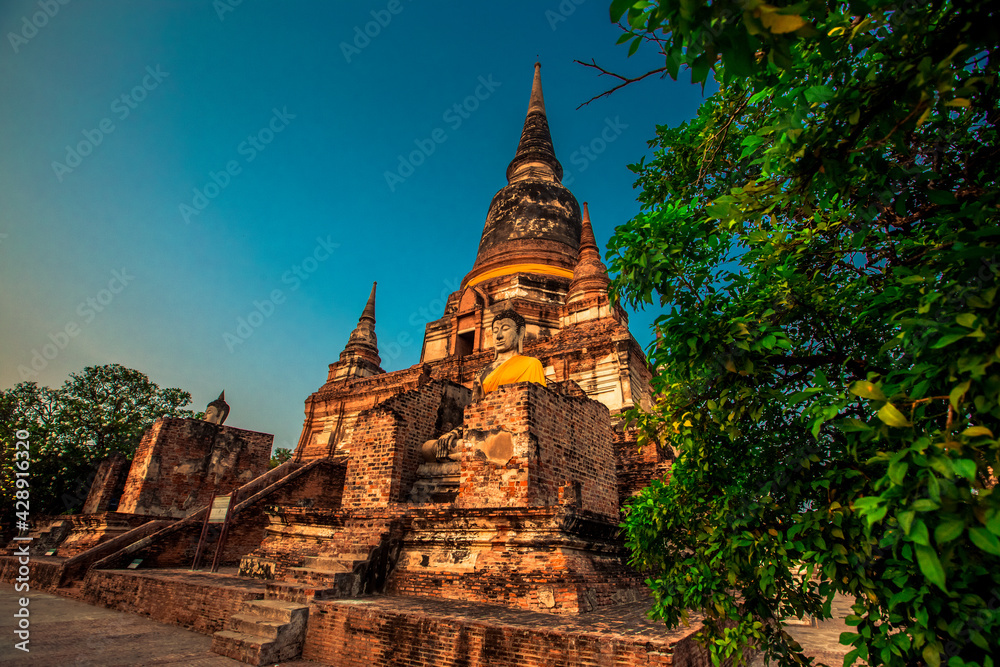 Fototapeta premium Background of old Buddha statues in Thai religious attractions in Ayutthaya Province, allowing tourists to study their history and take public photos.