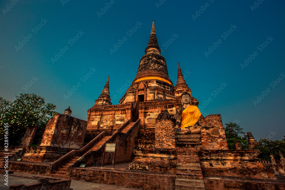 Fototapeta premium Background of old Buddha statues in Thai religious attractions in Ayutthaya Province, allowing tourists to study their history and take public photos.