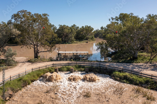 The flooded Darling river in the far outback of New South Wales with a pumping station filling irrigation canals near Bourke.