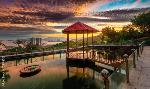 Pavilion on the pond at sunset. Panorama