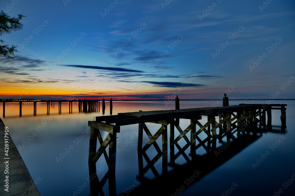 beautiful sunset colors broken down piers