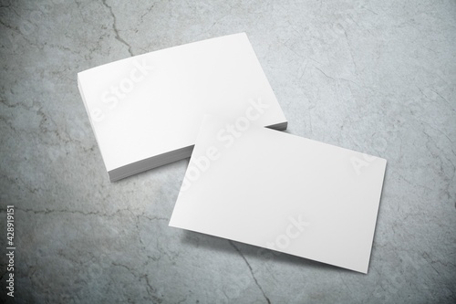 Blank white mockup of sheets or cards on the desk