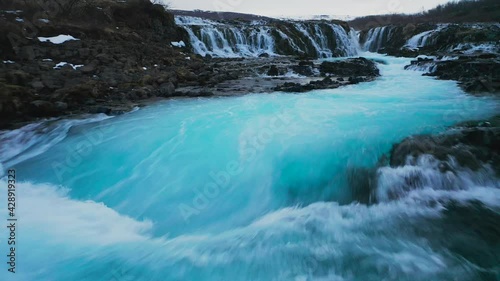 Bruarfoss Waterfall With Turquoise Stream In Iceland - aerial low photo