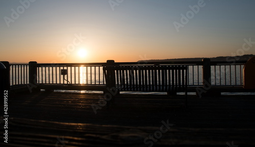 Fototapeta Naklejka Na Ścianę i Meble -  Watching sunset thru rail of Jorgensen Pier in Semiahmoo Bay