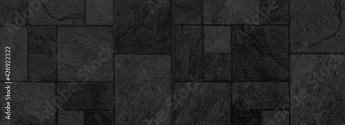 Panorama of Building exterior black granite block wall texture and background seamless