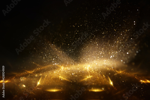 background of abstract gold and black glitter lights. defocused