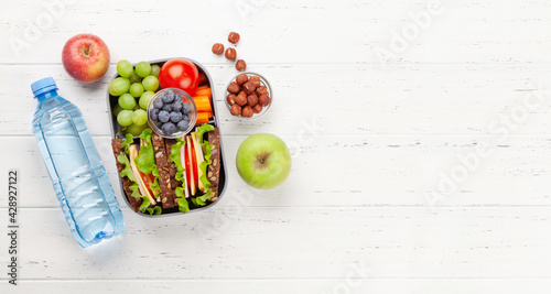Photography Healthy school lunch box with sandwich and fresh vegetables