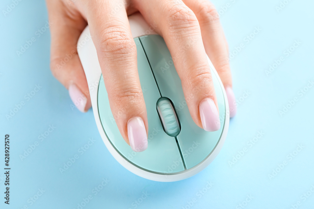 Female hand with computer mouse on color background. Erotic concept Female hand with computer mouse on color background. Erotic concept