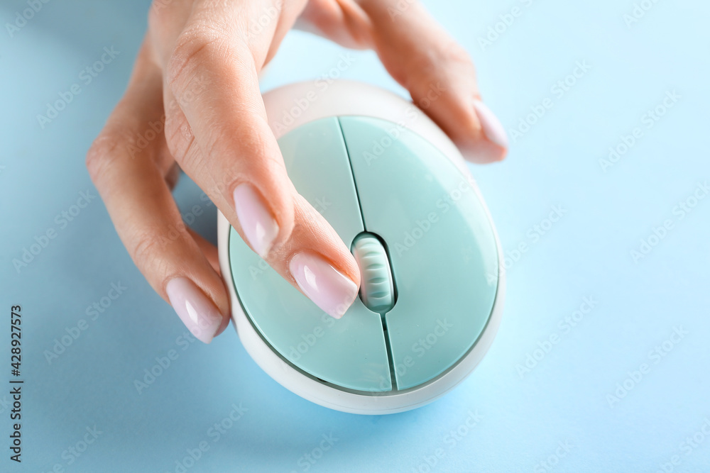 Female hand with computer mouse on color background. Erotic concept Female hand with computer mouse on color background. Erotic concept
