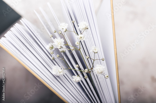 Book with fresh flowers, closeup