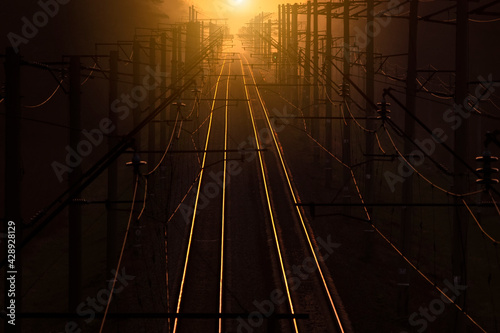 Fototapeta Naklejka Na Ścianę i Meble -  Railroad at sunset. Rail Freight and Passenger Transportation.