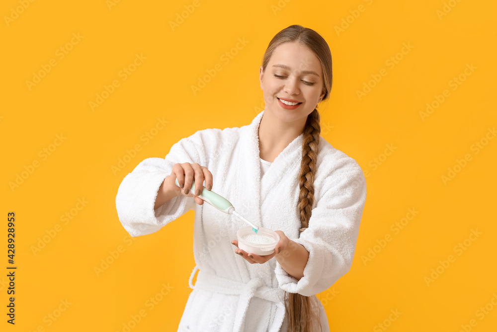 Young woman brushing teeth on color background Young woman brushing teeth on color background