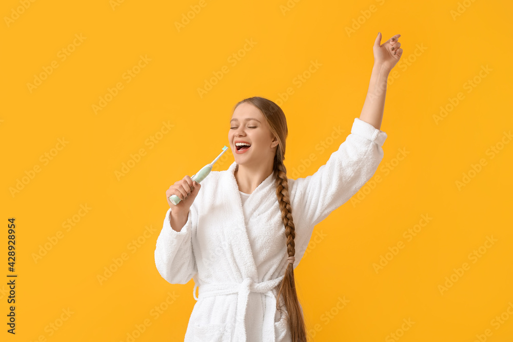 Singing young woman with tooth brush on color background Singing young woman with tooth brush on color background