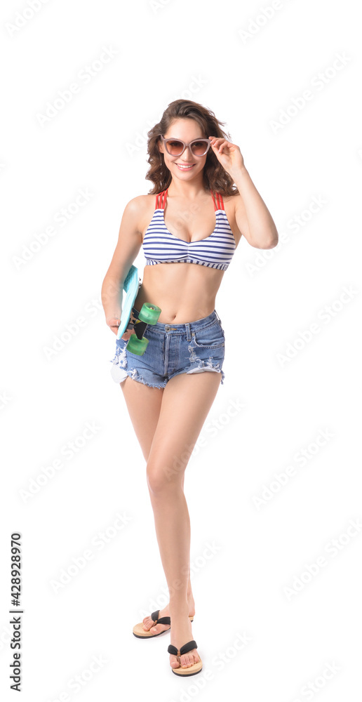 Beautiful young woman in beachwear and with skateboard on white background Beautiful young woman in beachwear and with skateboard on white background