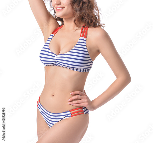 Beautiful young woman in swimsuit on white background