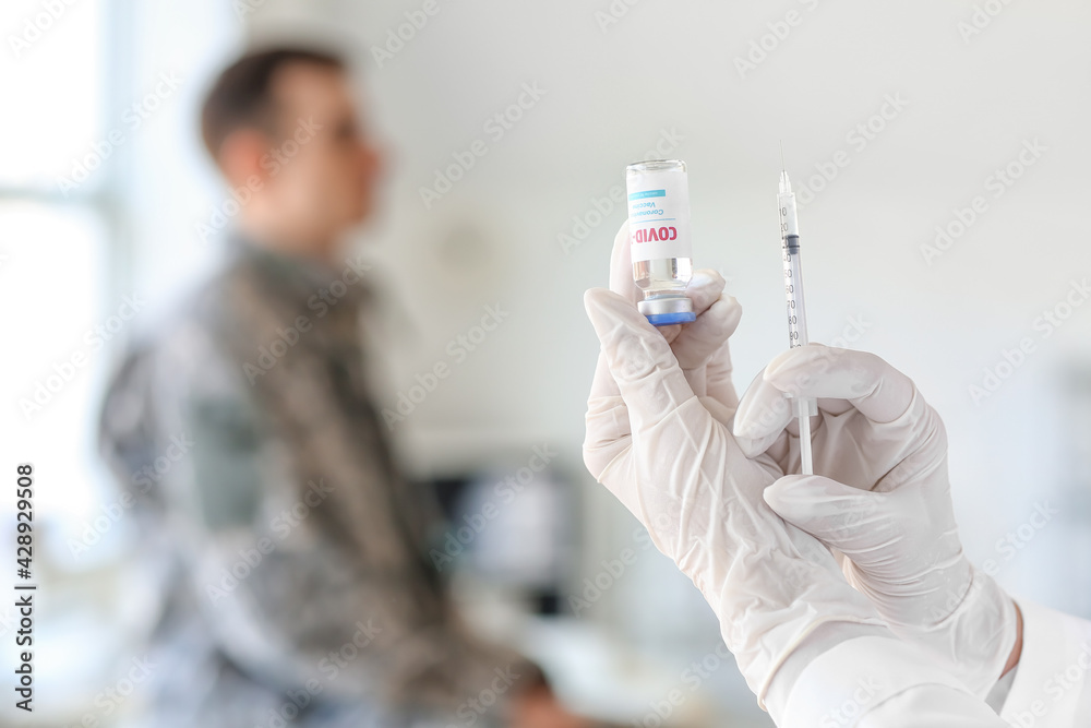 Doctor vaccinating patient against covid-19 in clinic Doctor vaccinating patient against covid-19 in clinic