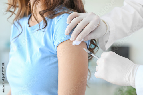 Fotografie Doctor vaccinating patient against covid-19 in clinic
