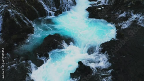 Reveal Shot Of The Beautiful Bruarfoss Waterfall On Bruara River In Iceland - aerial tilt up