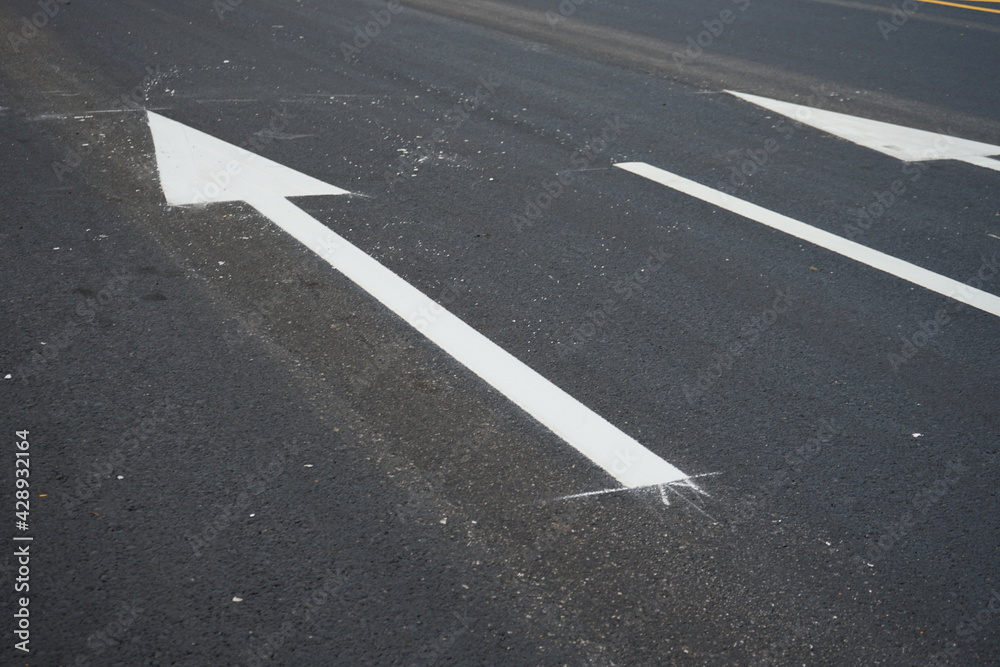 Technicians are marking a traffic line on a paved road. Technicians are marking a traffic line on a paved road.
