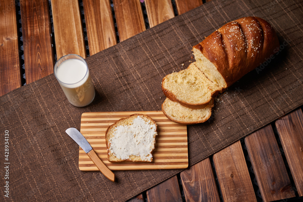 Bread and chesse spread with glass of milk on wooden table Bread and chesse spread with glass of milk on wooden table