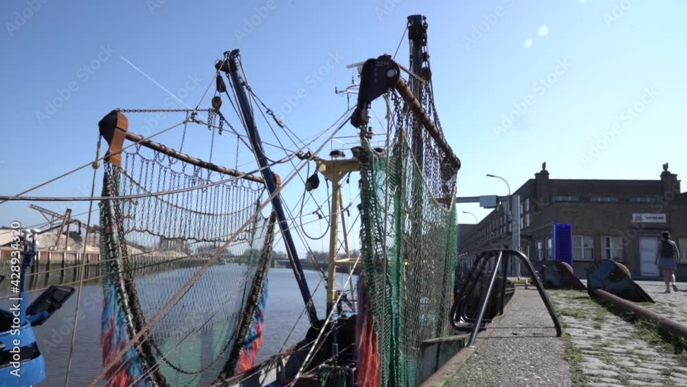 Fishing Dredge Hanging At The Harbor In Nieuwpoort, Belgium. Fish Market Industry. static shot Fishing Dredge Hanging At The Harbor In Nieuwpoort, Belgium. Fish Market Industry. static shot