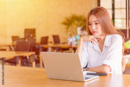 Young woman using laptop on her desk
