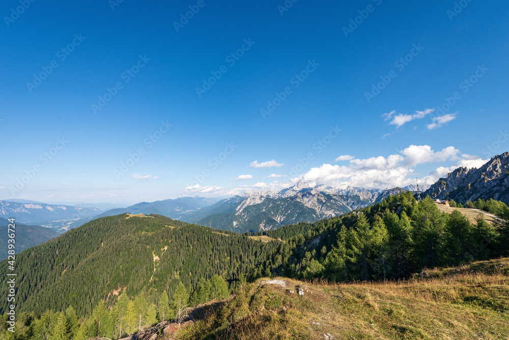 Summer Landscape in Julian Alps seen from the Monte Santo di Lussari, Val Canale Valley, Tarvisio, Friuli Venezia Giulia, Italy. On the horizon the Peak of the Mount Mangart and Austria.