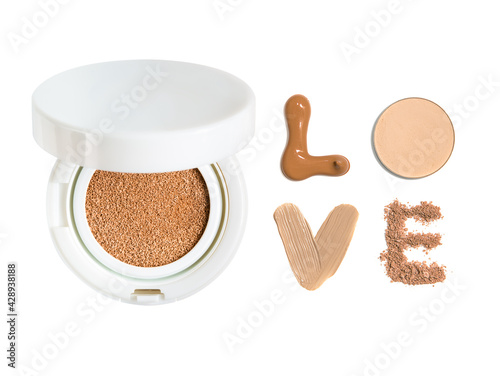 Powder cushion with the inscription love from samples of powder and foundation cream. Cosmetic face powder isolated on white background.