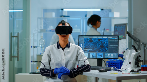 Laboratory doctor experiencing virtual reality using vr goggles in medical research lab. Therapist using medical innovation equipment device glasses, future, medicine, physician, vision, simulator. © DC Studio