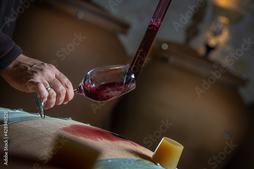 Bild auf Leinwand FRANCE, GIRONDE, SAINT-EMILION, SAMPLING A GLASS OF WINE IN A BARREL WITH A PIPE