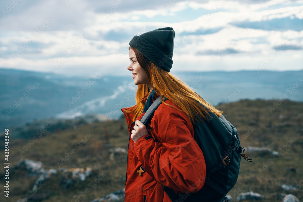 woman travels in the mountains landscape backpack red jacket and hat model woman travels in the mountains landscape backpack red jacket and hat model