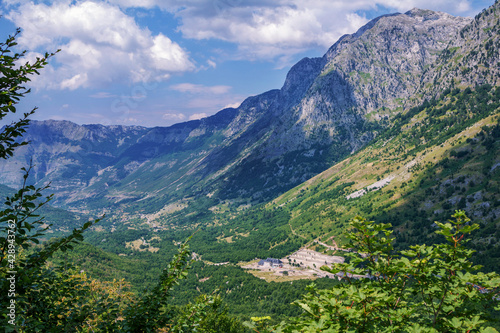 Summer landscape - Albanian mountains, covered with green trees and blue sky.