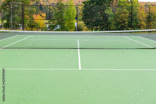 Empty tennis court in the park on sunny day © kelifamily