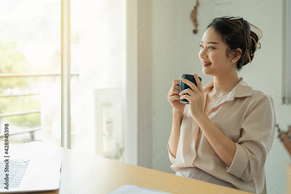Businesswoman having tea or coffee in home office. Businesswoman having tea or coffee in home office.