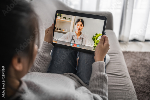patient women video conference remote on a tablet with a doctor for consultation the treatment of disease at home, work from home and social distancing concept.