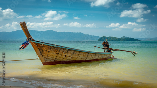 Long boat docked at the beach in Thailand