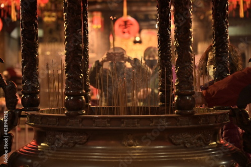 Jieyun Temple  Banqiao District  New Taipei City  Taiwan - February 12  2021  A worshiper is praying with incense.