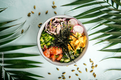 Organic hawaiian salmon poke bowl with rice and vegetables