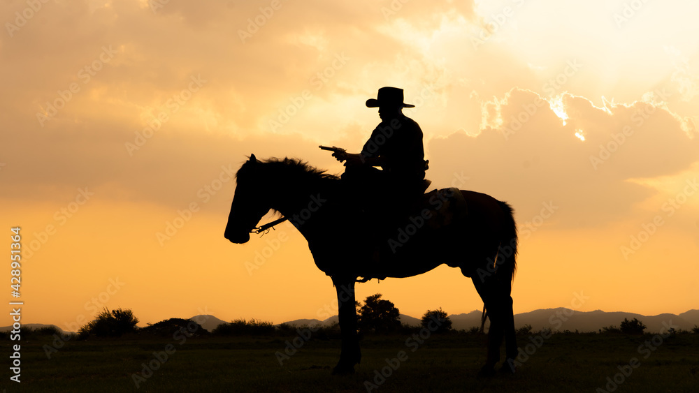 Silhouette Cowboy on horseback against a beautiful sunset, cowboy and horse at first light,mountain, river and lifestyle with natural light background.. Silhouette Cowboy on horseback against a beautiful sunset, cowboy and horse at first light,mountain, river and lifestyle with natural light background..