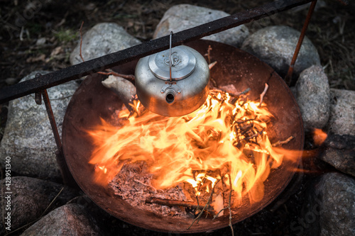 Metal kettle on a campfire