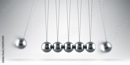 Balancing balls Newton's cradle on gray background