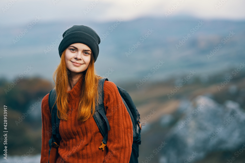 pretty woman tourist with backpack in autumn clothes mountains walk