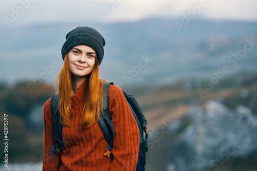 pretty woman tourist with backpack in autumn clothes mountains walk
