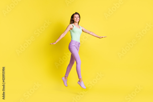 Profile photo of funny inspired lady step look camera wear green top pants footwear isolated yellow color background