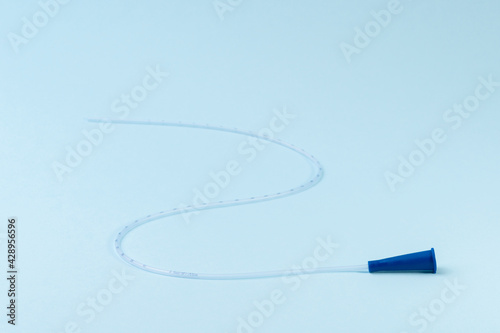 Rusch male and female all purpose catheter on blue background, straight tipped intermittent catheters designed for a single use photo