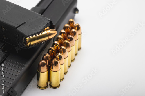 Gun magazines and bullets ammunition with pistol gun  on white background , Gun law photo