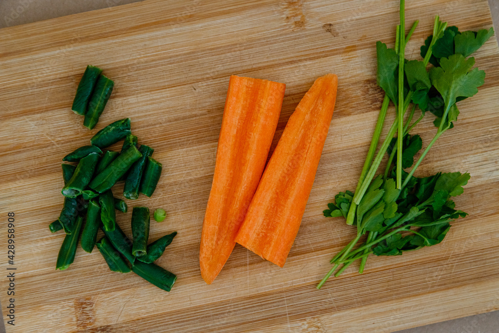 carrots and green on a wooden board
