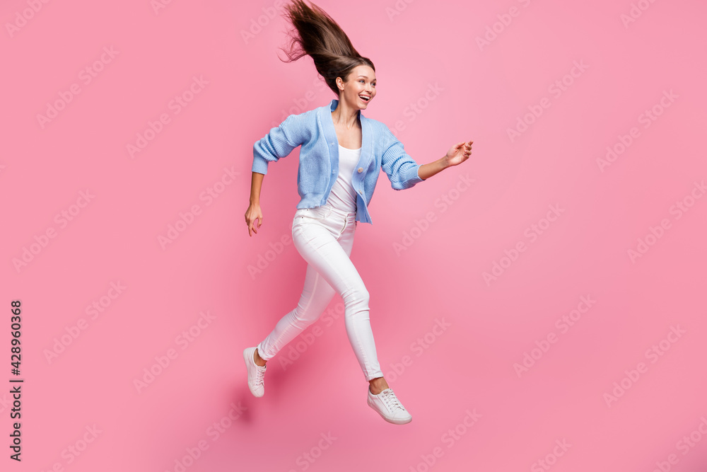 Full body profile side photo of excited girl look run copyspace jump air sale fly hair isolated on pastel pink color background