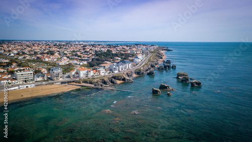 Aerial view from a magnificent coastline between cliffs  beaches  clear water and city. That place is called  Les 5 pineaux  located in Saint-Hilaire-de-Riez  France
